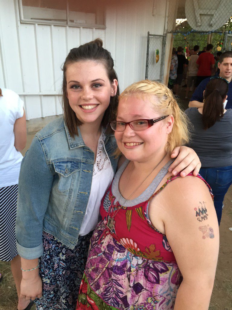 Volunteer Katie Freeman with camper Rania, whose hair she styled