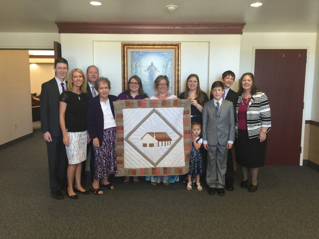 Sister Priscilla Baird, wife of the first Burleson Branch president, with presentation quilt and many of her posterity.